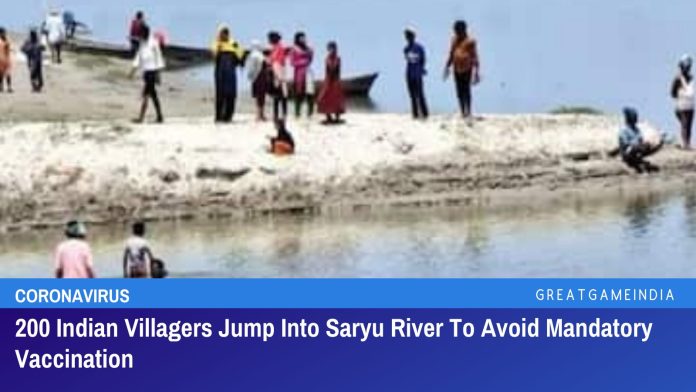 अनिवार्य COVID-19 टीकाकरण से बचने के लिए 200 भारतीय ग्रामीणों ने सरयू नदी में छलांग लगाई